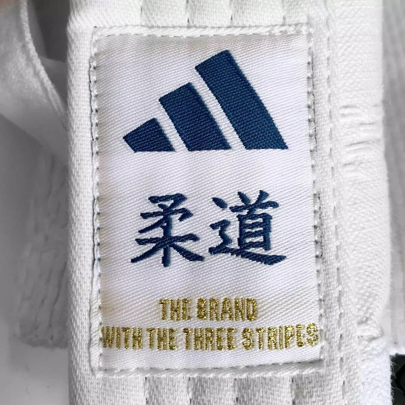 Judogi Adidas - Club 350 judopuku - Valkoinen, siniset raidat